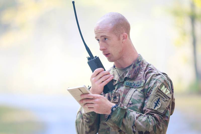 U.S. Army Staff Sgt. Timothy Quigley, assigned to U.S. Army Special Operations Command, relays his site assessment after clearing a chemical laboratory while competing in the 2017 Best Warrior Competition on Fort A.P. Hill, Virginia.
